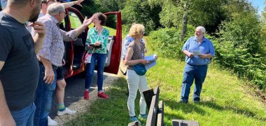 Das Foto zeigt Verantwortliche aus Ober-Hainbrunn und Jury-Mitglieder auf einer Anhöhe oberhalb des Dorfs.